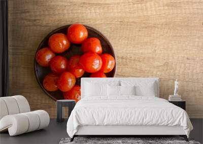 Pickled cherry tomatoes on a wooden table in rustic style. Canning concept Wall mural