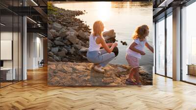 Summer evening by the Drava River in Osijek, Croatia with children playing near the water Wall mural