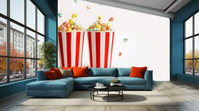 Two large filled glasses with colorful sweet popcorn for fun watching movies in the cinema. banner.  Popcorn is poured from the top into paper buckets Wall mural