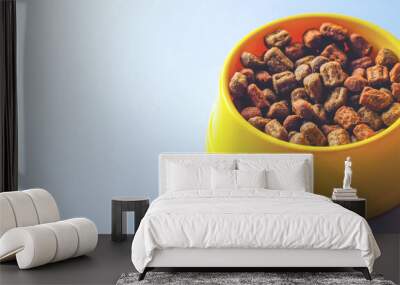 Yellow bowl with pet food. Wall mural