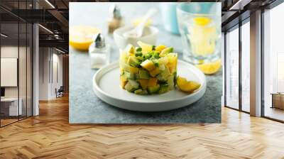 Delicious mango avocado salad on white plate Wall mural