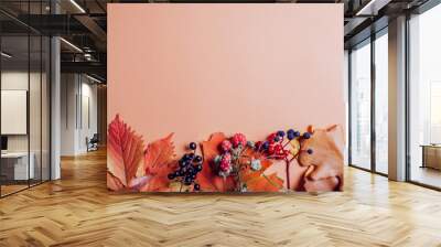 Fall background made of red yellow brown orange leaves and berries. Autumn floral design decor. Space. Top view Wall mural