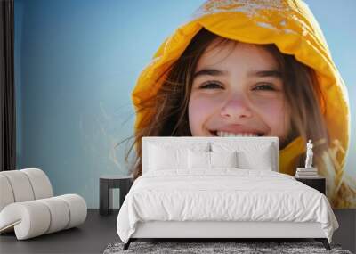 Smiling teenage girl wearing a yellow hooded jacket on a sunny day AI generated image Wall mural