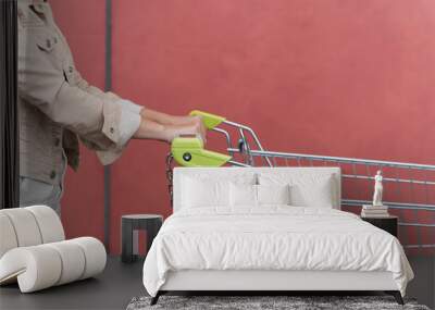 Closeup of female shopper with trolley at supermarket Wall mural