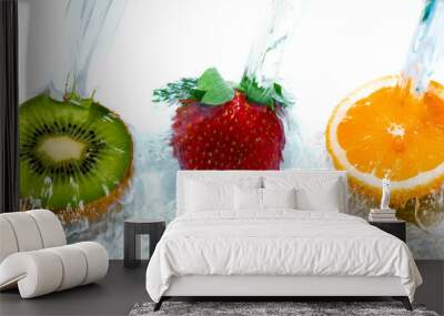 Fresh fruit jumping into water with a splash. Wall mural