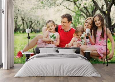 big family with three little daughters spending time together in summer park, mother, father and sisters having fun outdoor Wall mural