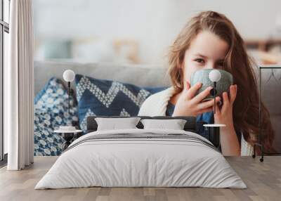 child girl drinking hot tea to recover from flu. Healing kids and protect immunity from seasonal virus, health concept Wall mural