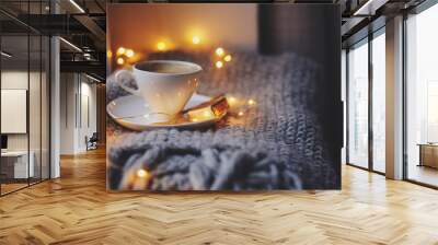 cozy winter or autumn morning at home. Hot coffee with gold metallic spoon, warm blanket, garland and candle lights, swedish hygge concept. Wall mural