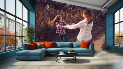 happy mother and daughter on the walk on summer field. Family spending vacation outdoor, lifestyle capture, cozy mood. Wall mural