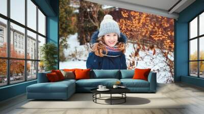 winter lifestyle portrait of happy kid girl playing snowballs on the walk on backyard Wall mural