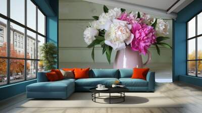 A bouquet of pink and white peonies on the table in a rural house. Wall mural