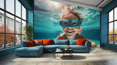 a child, a boy, swims in the pool wearing goggles for swimming underwater. water treatments, a kind of sport. Wall mural