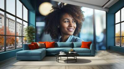 A happy professional black woman, light blurry background  Wall mural