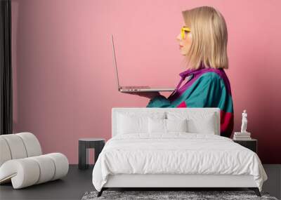 Beautiful blonde woman in 90s clothes with laptop computer Wall mural