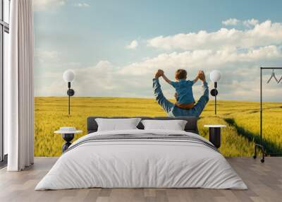 father and son in wheat field, child sitting on his fathers shoulders Wall mural