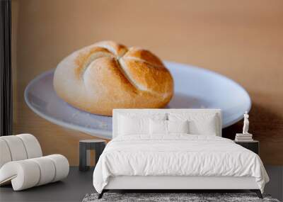 Kaiser roll on a plate on wooden table Wall mural