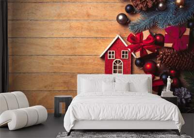 little wooden house and Christmas decoration on wooden table. Above view in old color style Wall mural