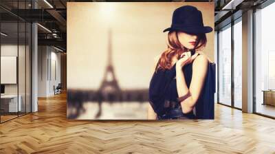 Redhead women with shopping bags on parisian background. Wall mural