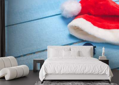 Sunglasses and christmas hat on blue wood Wall mural