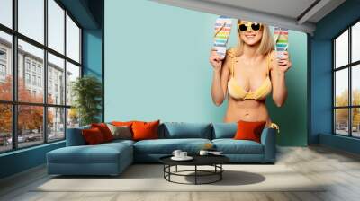 woman in yellow bikini and sunglasses with flip-flops Wall mural