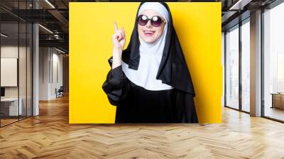 Young happy nun with sunglasses Wall mural