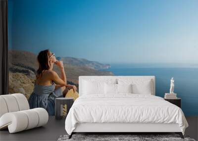 Young redhead girl in hat and dress with sea coastline on Balos, Crete, Greece Wall mural