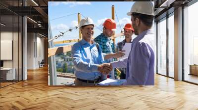 Builders Handshake, Two Happy Smiling Partners Shaking Hand After Meeting With Foreman Team On Building Construction Site Wall mural