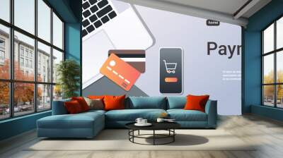 online shopping mobile application internet payment concept top angle view desktop smartphone laptop screen credit card office stuff horizontal copy space Wall mural