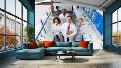 Professor With Mix Race Group Of Scientists In Modern Laboratory Top Angle View Of Smiling Team Of Doctors In Lab Portrait Wall mural