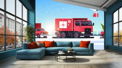 trucks pickup car driving road quadcopters with gift boxes delivery shipping transport merry christmas happy new year winter holidays concept horizontal snowy cityscape background vector illustration Wall mural