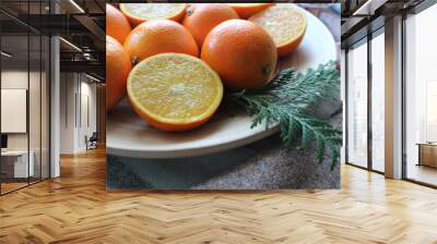 Lots of oranges and slices on a white plat Wall mural