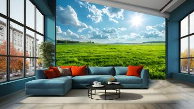 Beautiful natural scenic panorama green field of cut grass into and blue sky with clouds on horizon. Perfect green lawn on summer sunny day Wall mural