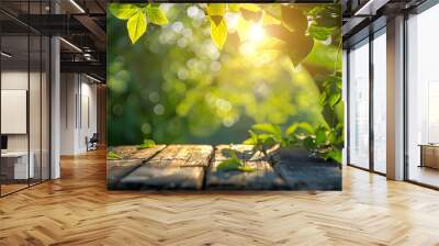 Spring summer beautiful natural background with green foliage in sunlight and empty wooden table outdoors Wall mural