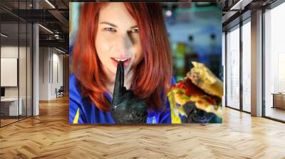 Girl with a juicy burger. Beautiful happy young woman with tasty burger on light background. Girl holds juicy cheeseburger. Wall mural