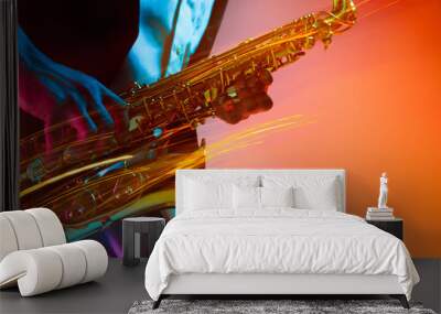 African American handsome jazz musician playing the saxophone in the studio on a neon background. Music concept. Young joyful attractive guy improvising. Close-up retro portrait. Wall mural