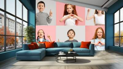 Art collage made of portraits of little and happy kids isolated on multicolored studio background. Human emotions, facial expression concept Wall mural