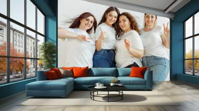 Beautiful. Young caucasian women in casual having fun together. Friends posing on white background and laughting, looks happy, well-kept. Bodypositive, feminism, loving themself, beauty concept. Wall mural