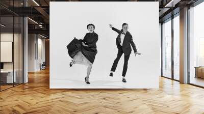 Black and white. Happy, positive, smiling young people, man and woman in elegant clothes dancing lindy hop. Concept of hobby, retro dance, vintage style, choreography, beauty. Monochrome art. Ad Wall mural