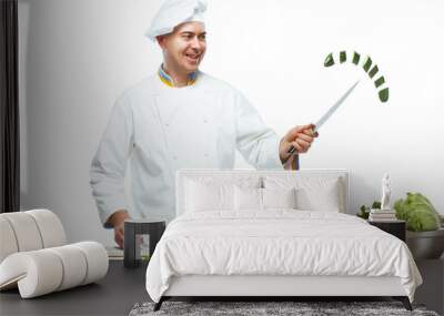 Chef cutting a green cucumber in his kitchen Wall mural