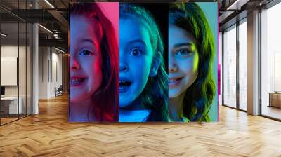 Children's emotions. Set of portraits of cute kids, charming little girls isolated on multicolored background in neon light. Wow emotions, facial expression and carefree childhood concept. Wall mural