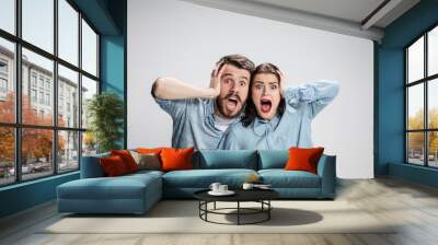 Close up photo of angry man and woman touching their heads Wall mural