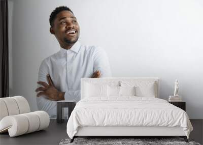 Close up portrait of a happy excited young african american man laughing against gray background. Wall mural