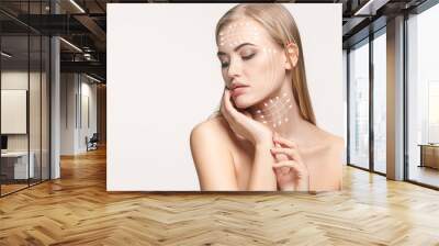 Close-up portrait of young, beautiful and healthy woman with arrows on her face. The spa, surgery, face lifting and skin care concept Wall mural