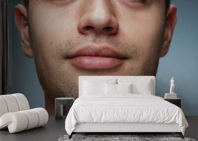 Close-up portrait of young man isolated on grey studio background. Caucasian male model's face and lips. Concept of men's health and beauty, self-care, body and skin care. Wall mural