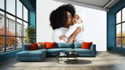 Closeup portrait of beautiful african woman holding on hands her little daughter on white background. Family, love, lifestyle, motherhood and tender moments concepts. Mother's day concept or Wall mural