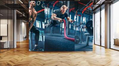 Collage about men with battle rope and woman in the fitness gym. The gym, sport, rope, training, athlete, workout, exercises concept Wall mural