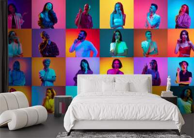 Collage made of portraits of different men and women raising finger up against multicolored background in neon light. Ideas. Concept of human emotions, youth, lifestyle, facial expression. Ad Wall mural