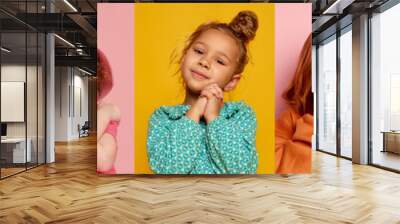 Collage. Beautiful kids, little girls posing, showing different emotions of shock, happiness posing over multicolored background Wall mural