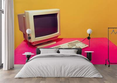 colorful image of vintage computer monitor and keyboard on bright pink tablecloth over yellow backgr Wall mural