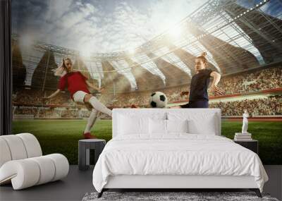 Concentrated young women, soccer, football players in motion, during match, playing o 3D football arena under open air. Concept of professional sport, competition, dynamics, game, ad Wall mural